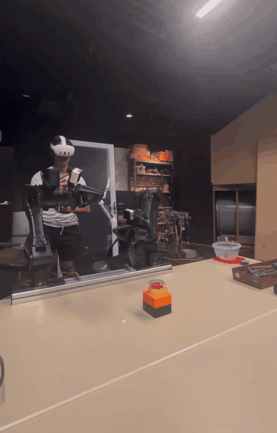 A lab member teleoperating robot arms with a VR headset